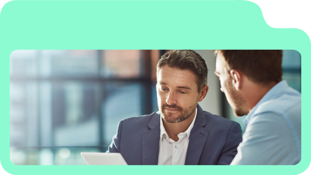 Two professionals discussing client portal features